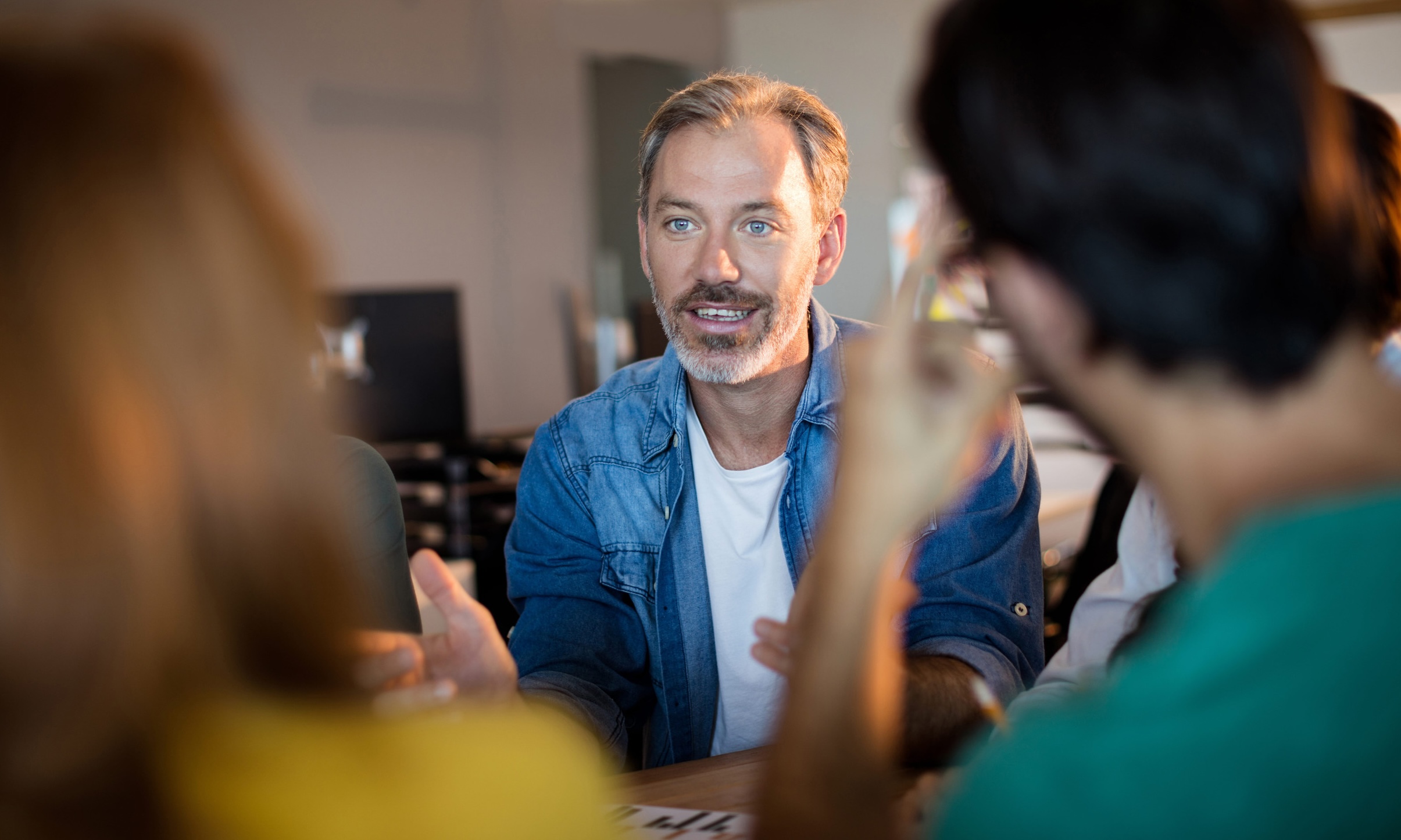 Person in a blue shirt speaking in a support group