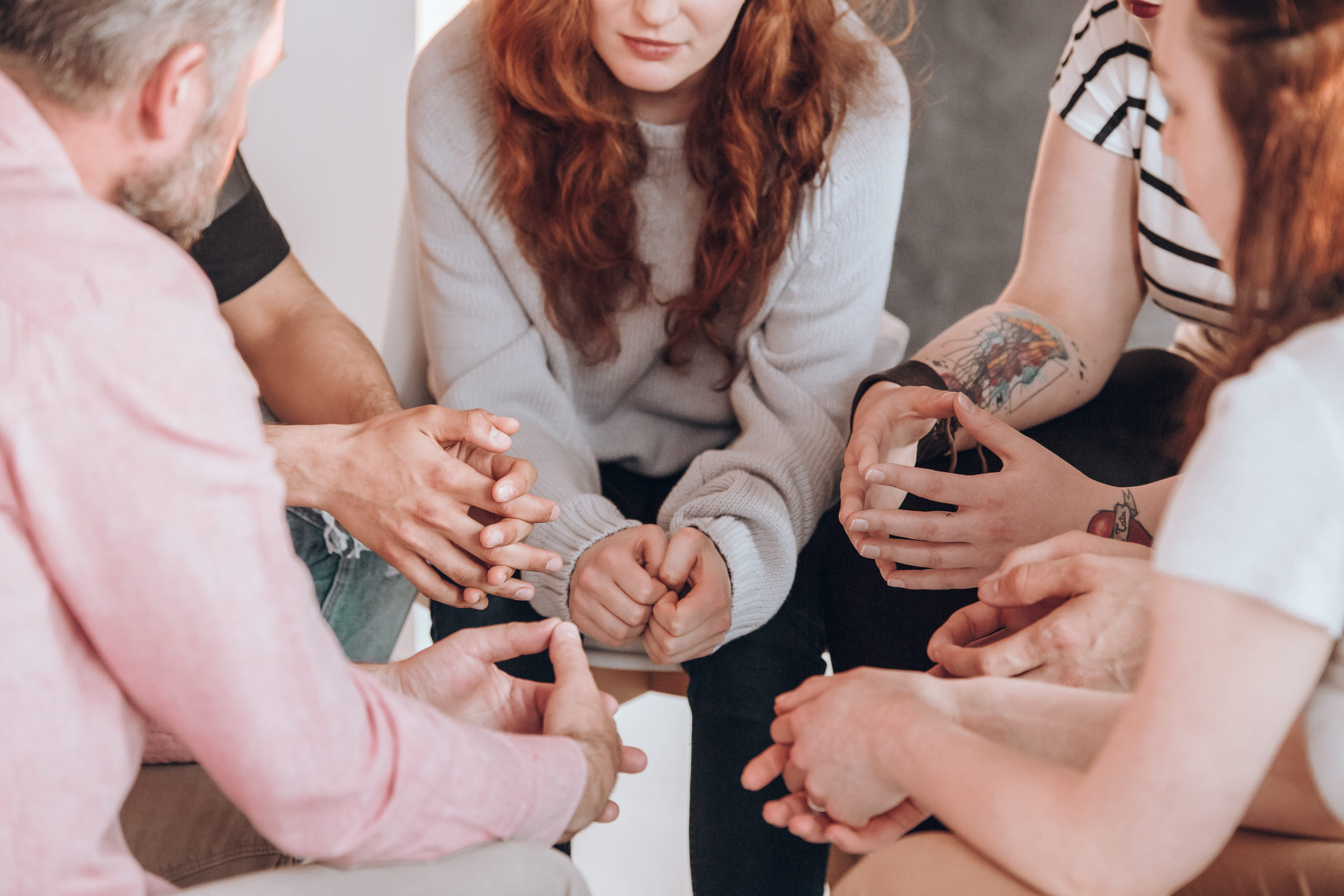 People gathered closely together in a grief support group